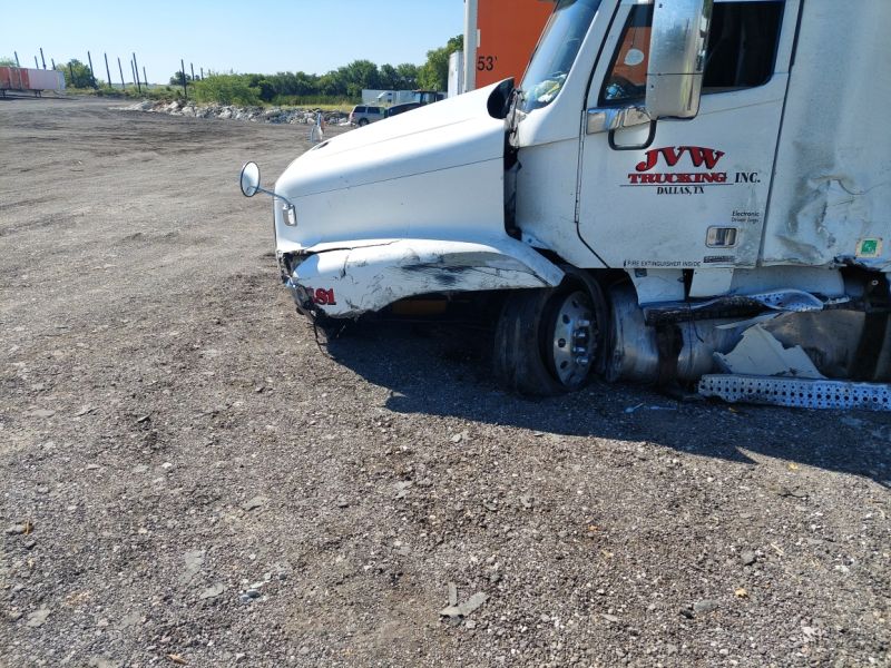 crashed semi truck with steer tire blowout